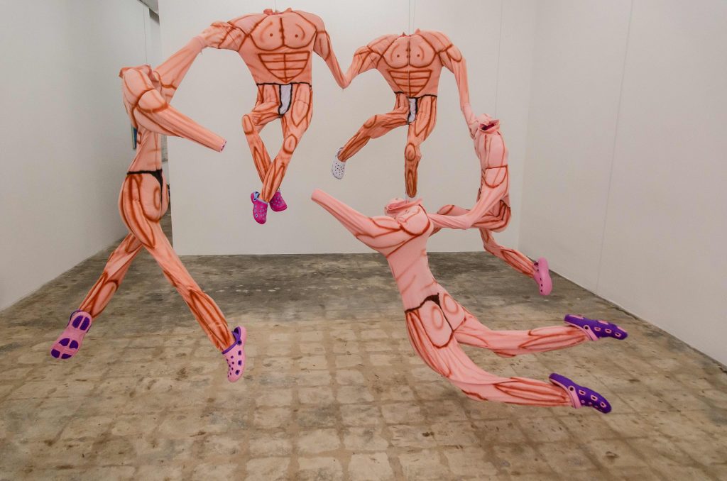  Bodies, 2019 Muscle suits, Croc shoes, PVC, mixed media 10 x 9 x 7 ft